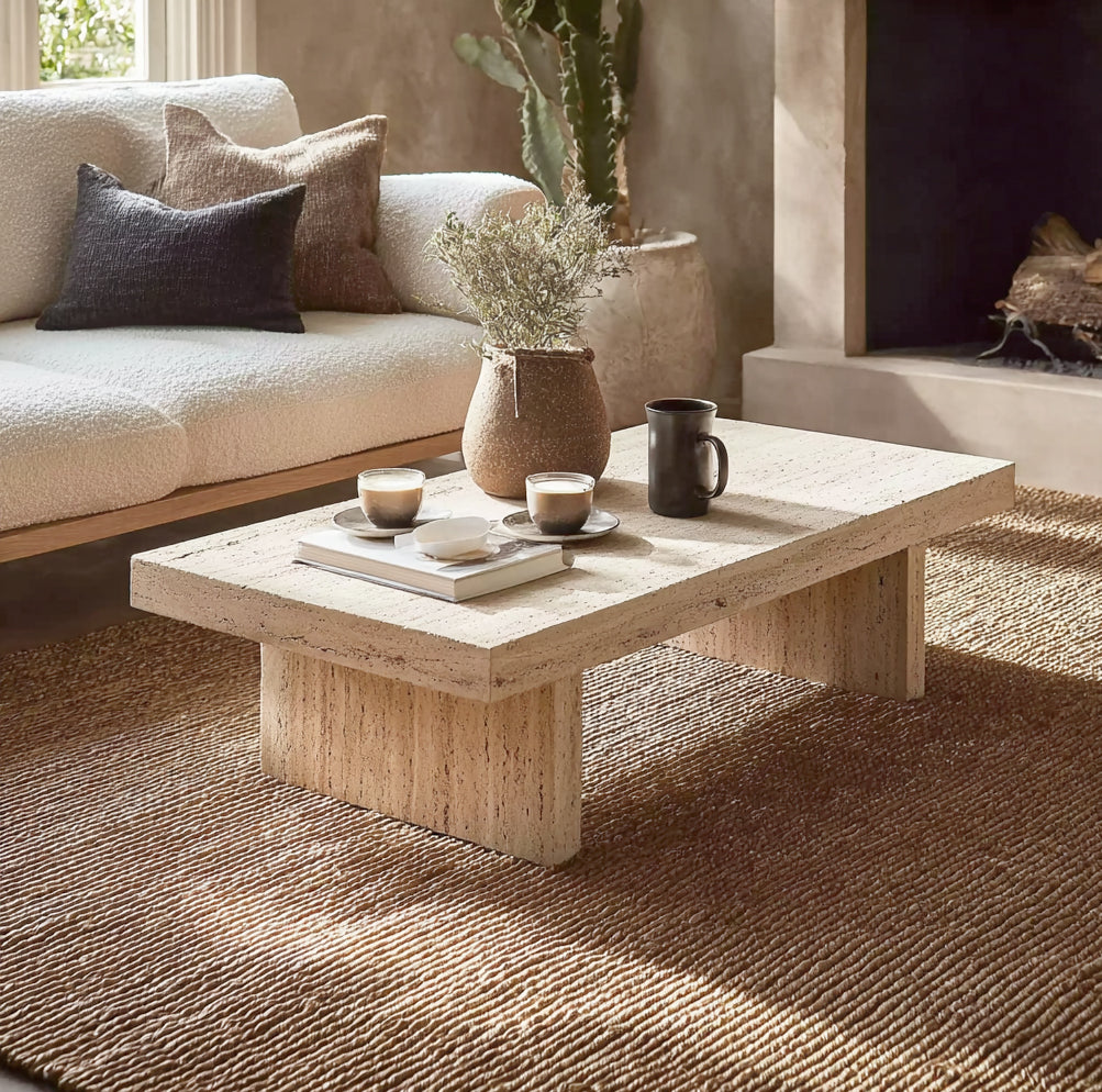Modern solid wood coffee table with natural finish in cozy living room, styled with ceramics and books.